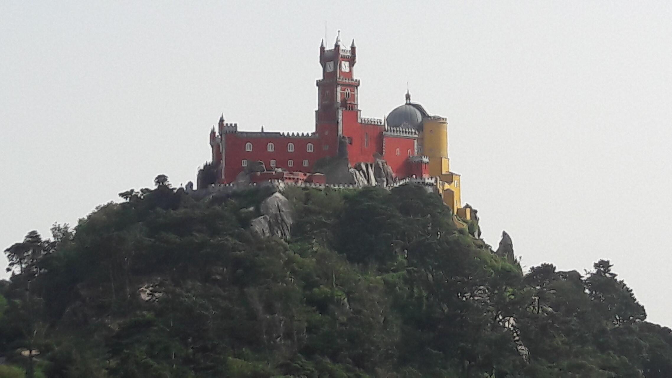 Le Palais de Pena à Sintra près de Lisbonne au Portugal, avec sa façade ocre rouge, au sommet d’une colline.